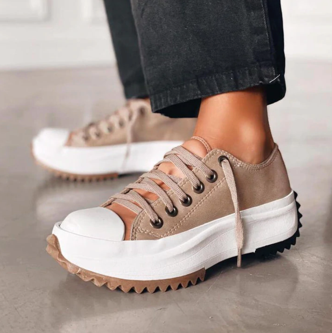 Women's trendy white platform sneakers with lace-up design, perfect for casual everyday fashion.