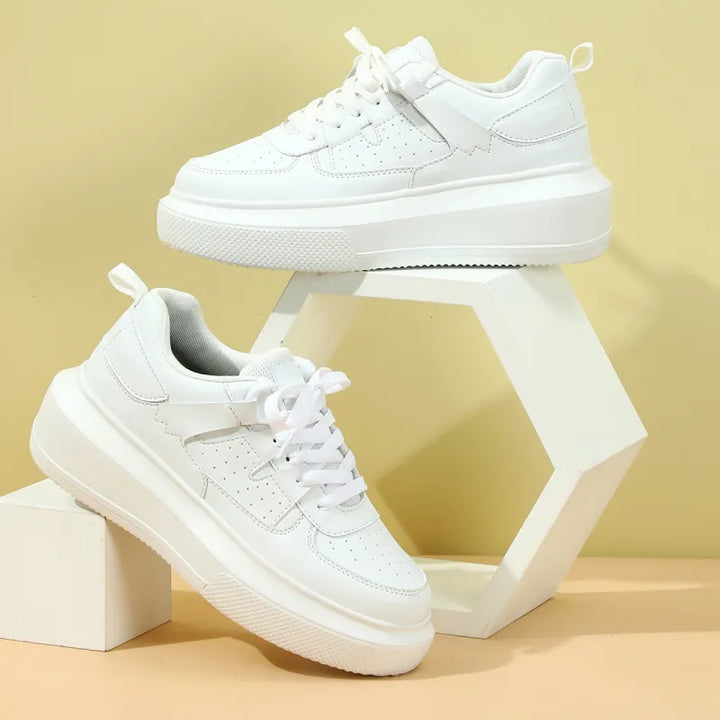 Women's trendy white platform sneakers with lace-up closure and perforated details for casual everyday style.