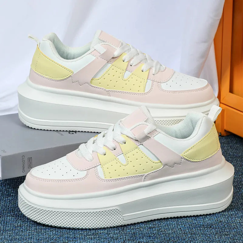 White perforated platform sneakers for women, featuring a stylish lace-up design, perfect for modern streetwear.