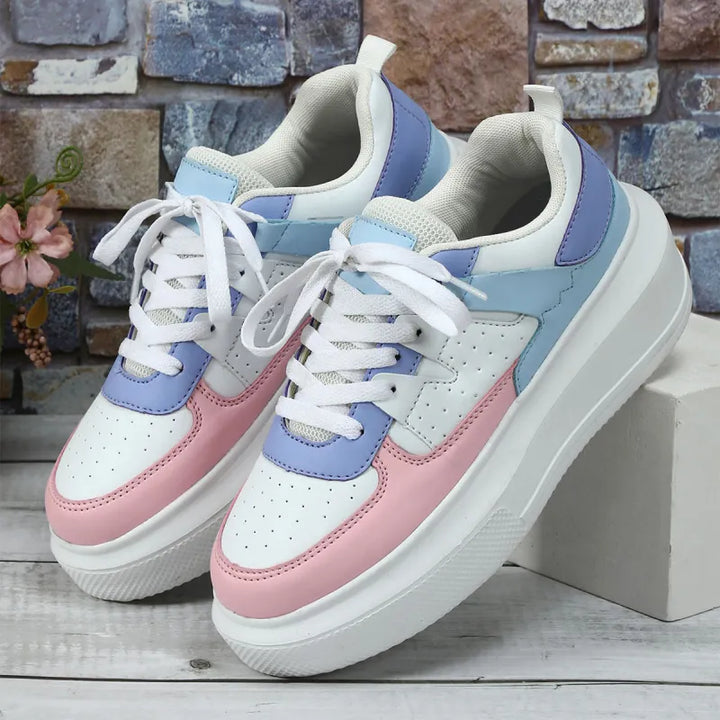 Comfortable women's platform sneakers with chic perforations and lace-up front, ideal for trendy casual wear.