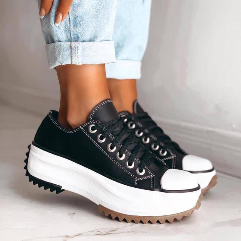 Front view of women's white platform sneakers, showcasing the trendy elevated sole and comfortable fit.