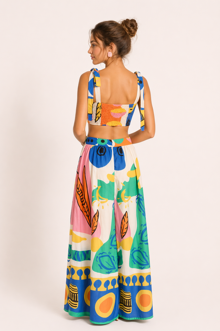 Vibrant tropical print two-piece set: sleeveless crop top & flowing maxi skirt. Chic women's summer fashion.