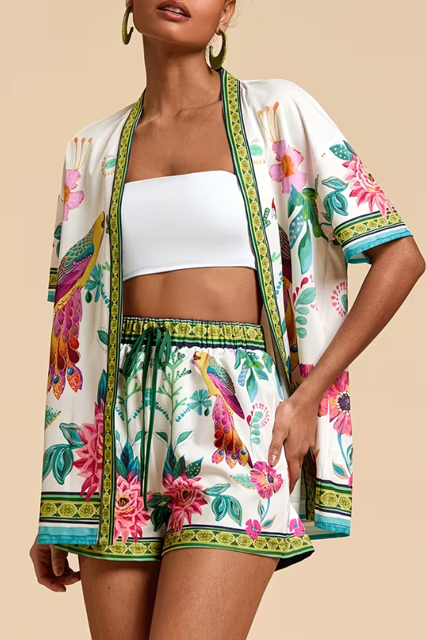 Casual women's summer matching set with vibrant tropical floral print top and shorts for a beach day.