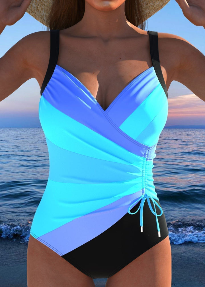 Vibrant floral printed one-piece women's swimwear with tummy control for beach.