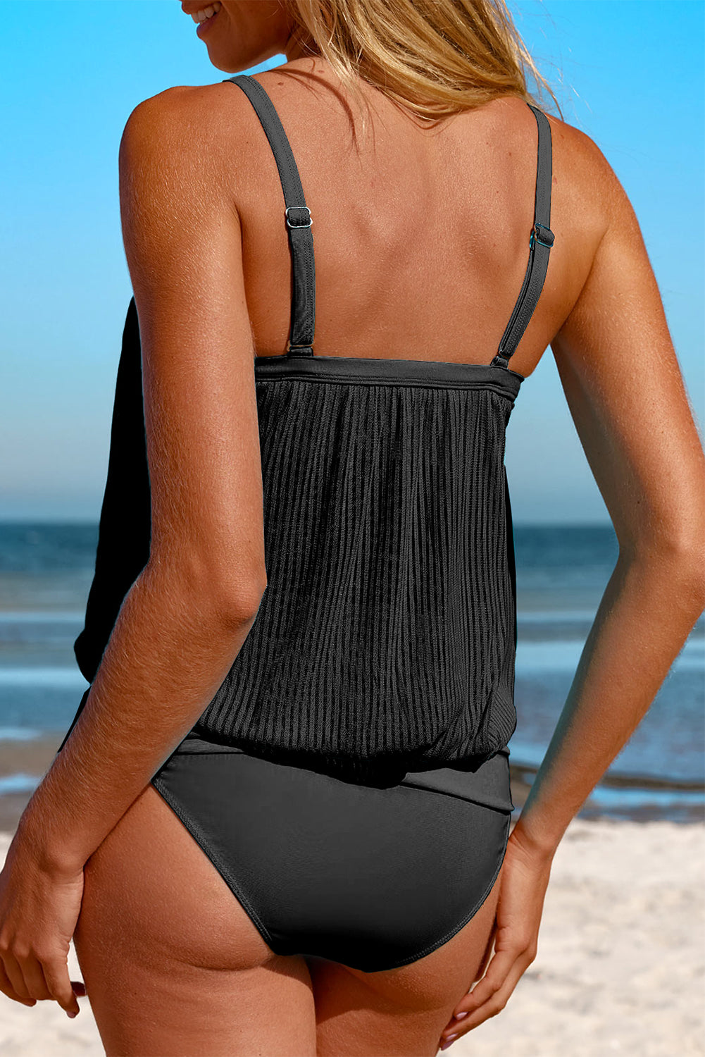 Vibrant turquoise and black striped tankini swimsuit with comfortable fit, great for a summer holiday.