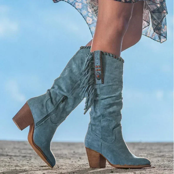 Festival-ready women's turquoise fringe western boots. Studded, mid-calf, perfect for a cowgirl look.