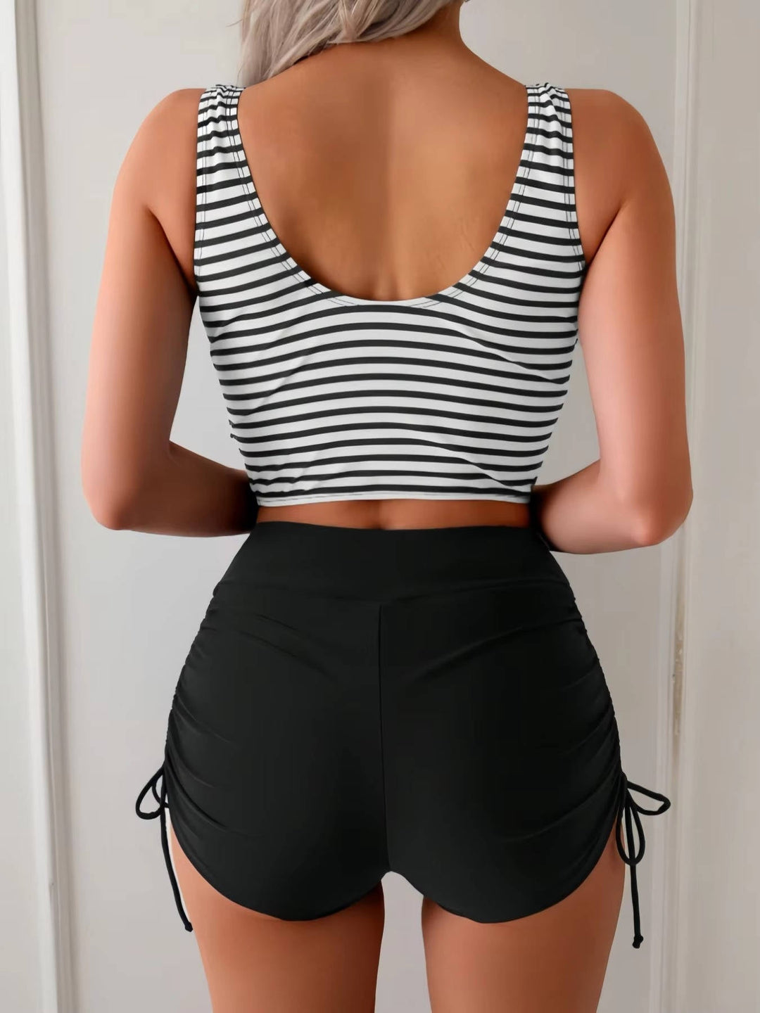 Stylish women's twist front tankini, high waisted design for tummy control, ideal for pool days.