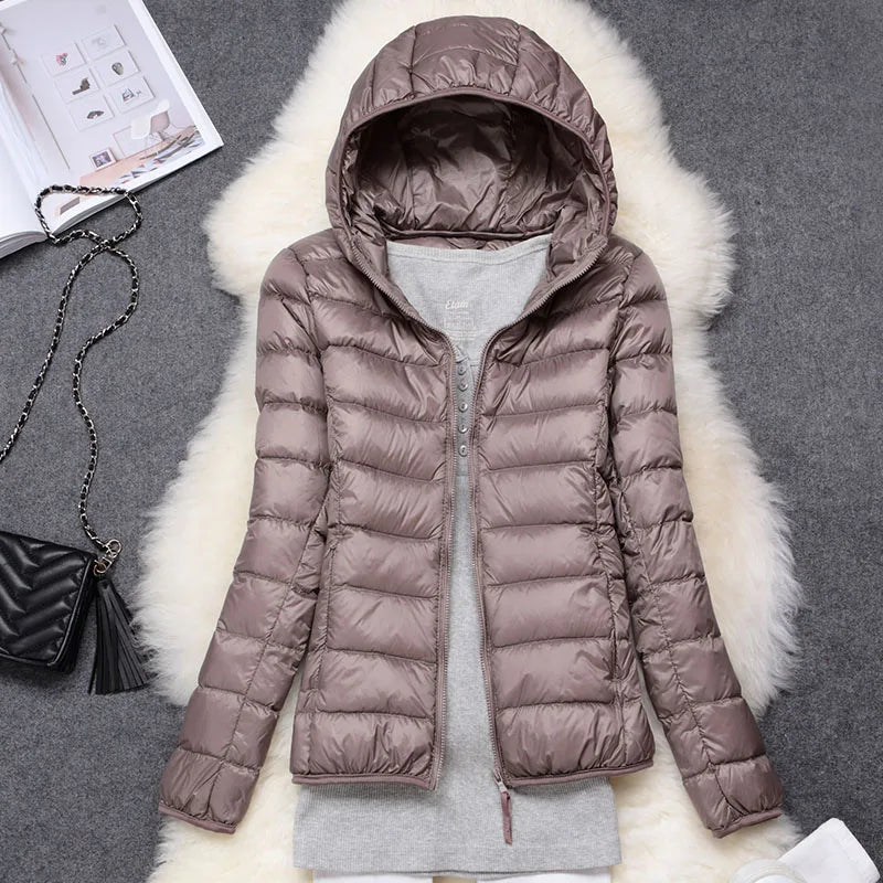 Women's ultralight insulated hooded jacket, offering essential winter warmth & packable convenience.