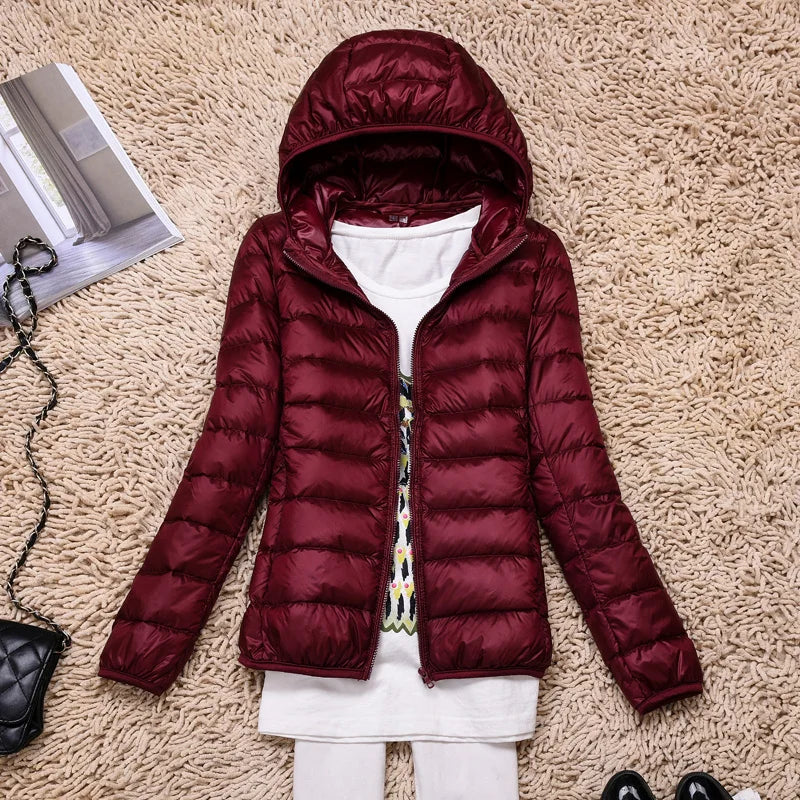Modern women's hooded jacket, ultralight insulation provides excellent winter warmth and packability.