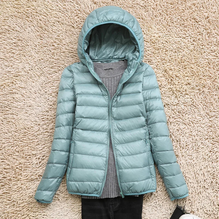 Cozy women's ultralight insulated hooded jacket, perfect for chilly fall evenings & winter comfort.