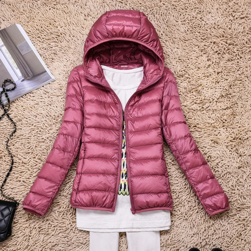 Functional women's hooded jacket, ultralight insulated design ensures winter warmth and easy packing.