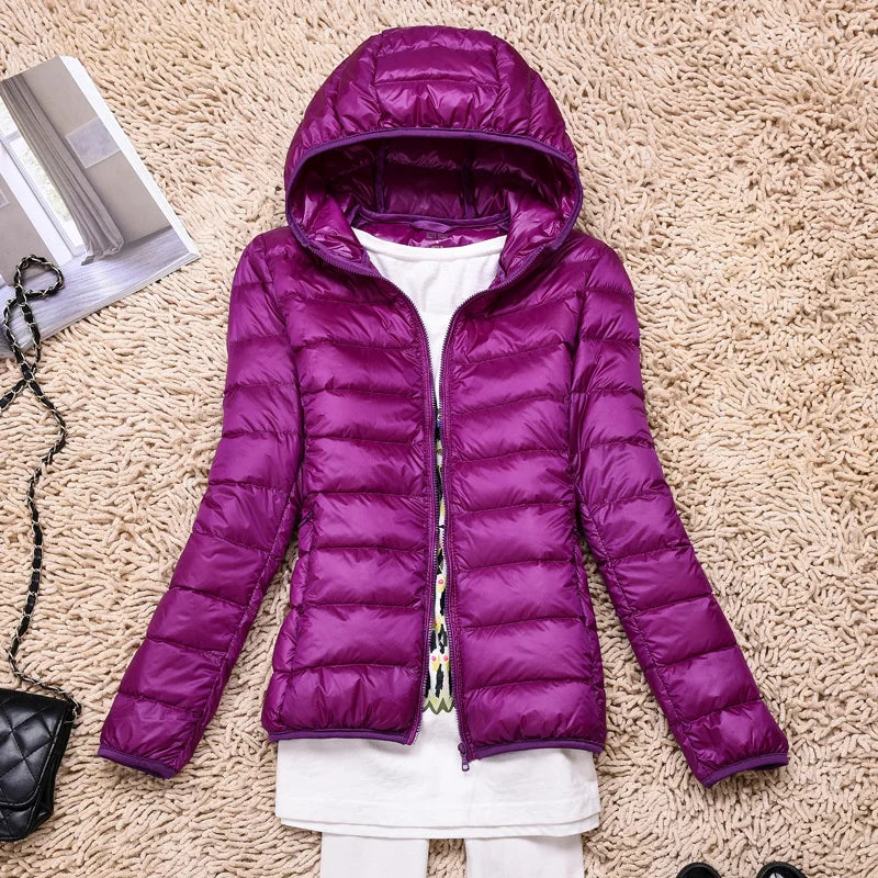 Women's winter warmth jacket, ultralight, insulated, and hooded; ideal for travel & everyday wear.