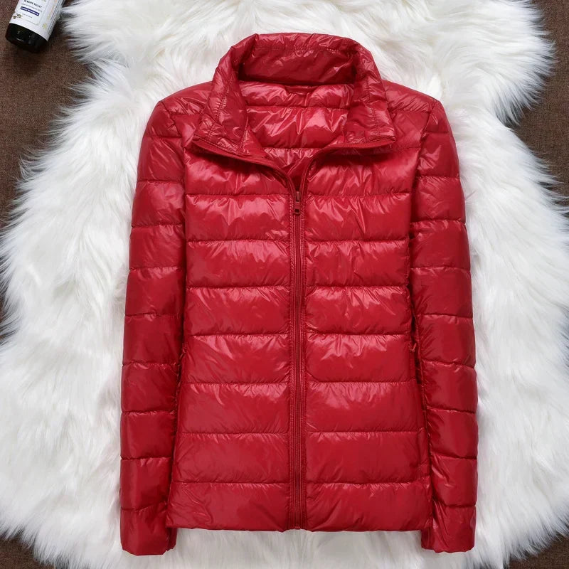 Lightweight women's insulated hooded jacket, ultralight and packable for versatile winter outerwear.