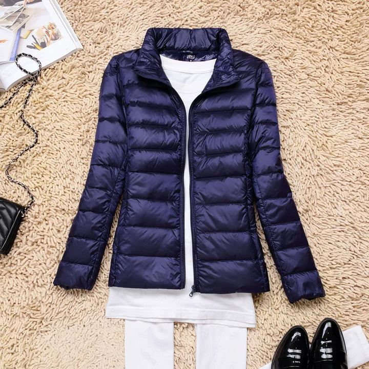 Premium women's ultralight insulated hooded jacket, essential for maximum winter warmth & style.