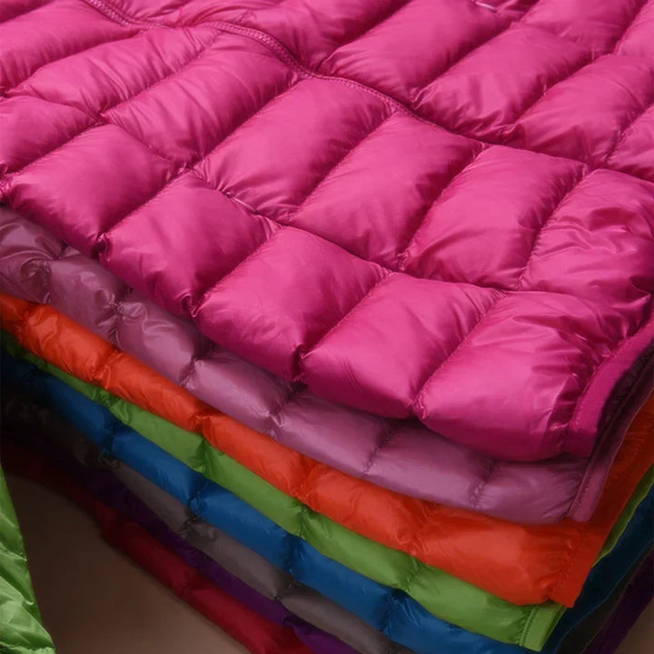 Comfortable women's hooded jacket, ultralight insulation ideal for fall outings & winter adventures.