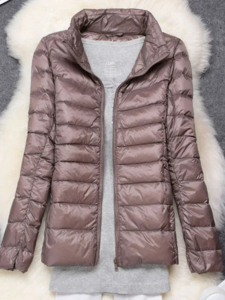 Warm women's ultralight hooded jacket, essential outerwear for cold weather and packable convenience.