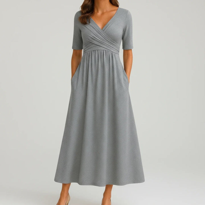 Women's V-neck A-line midi dress with pockets, perfect for casual spring and summer wear.