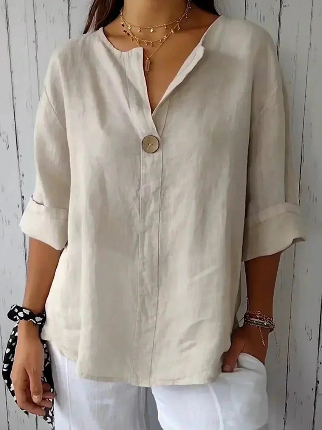 Relaxed fit V-neck blouse for women, showcasing adjustable roll-tab long sleeves for versatile styling.