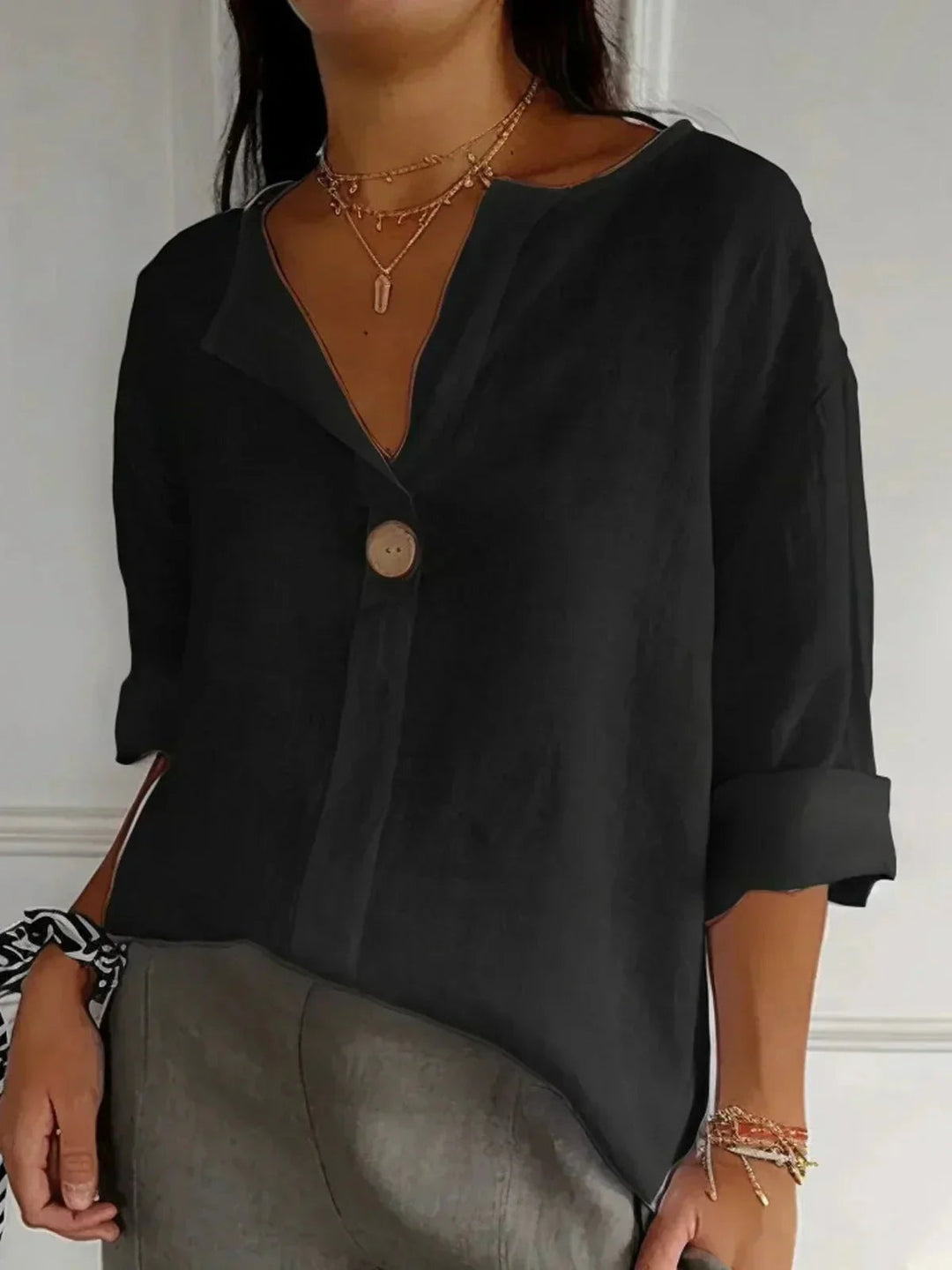 Stylish women's V-neck blouse, a versatile button-down with roll-tab sleeves for office or daily wear.