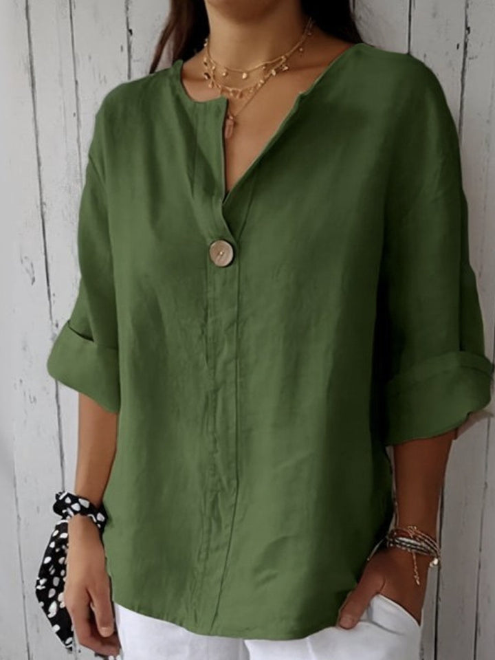 Soft V-neck blouse for women with adjustable roll-tab sleeves, a casual yet chic button-down top.