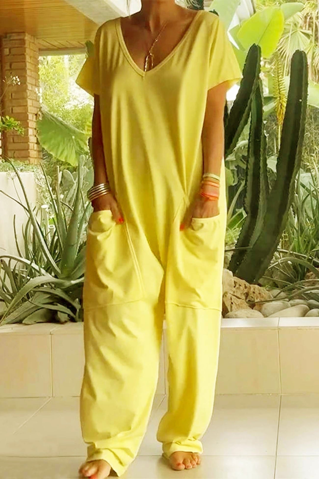 Stylish women's V-neck short sleeve jumpsuit with a modern dropped crotch & relaxed silhouette.