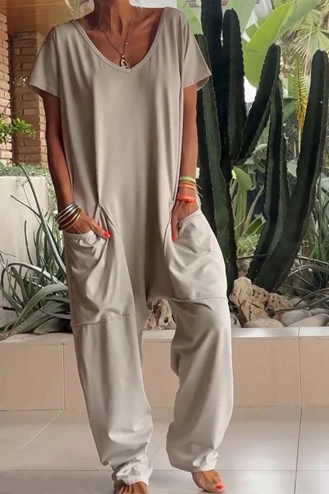 Women's V-neck, short sleeve, relaxed fit jumpsuit with a trendy dropped crotch. Comfortable one-piece.