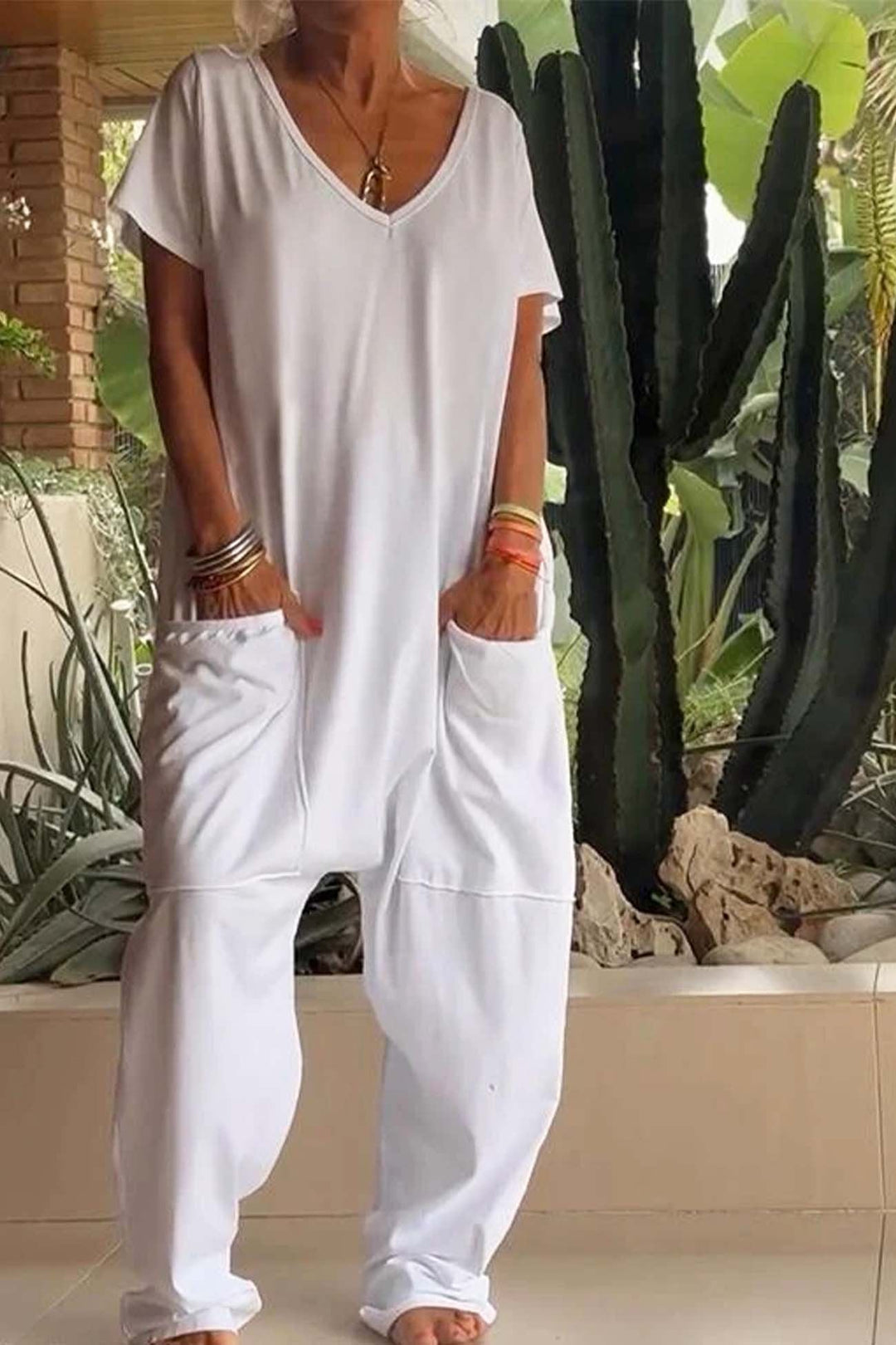Women's casual V-neck jumpsuit with a relaxed fit and dropped crotch, great for comfort and style.