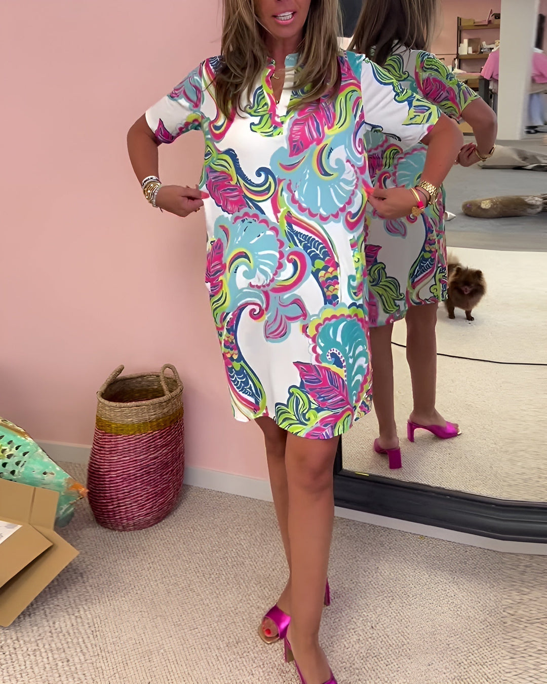 Flowy women's v-neck draped dress with a vibrant print. Comfortable, versatile & offers a flattering fit for day wear.