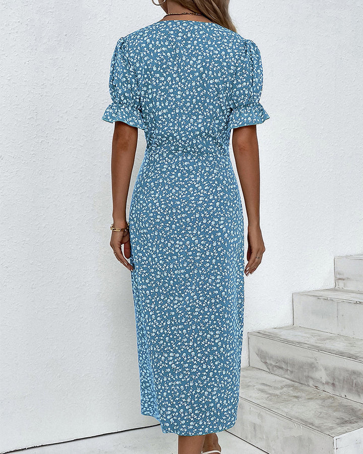 Full view of a women's V-neck floral flowy dress, highlighting the relaxed fit and vibrant print.