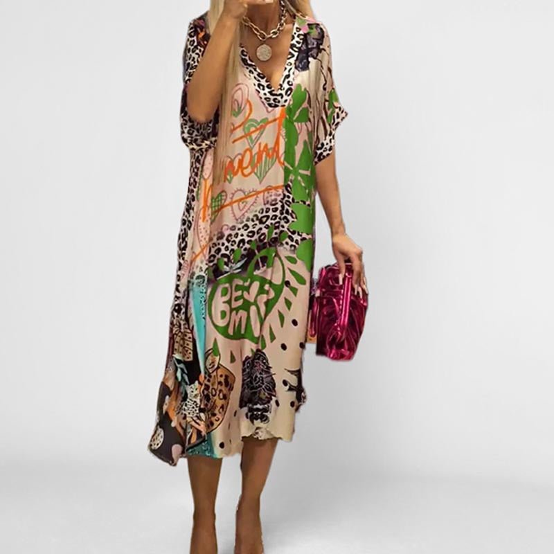 Flowy women's graphic print short sleeve tunic dress. Comfortable V-neck swing dress for summer casual wear.