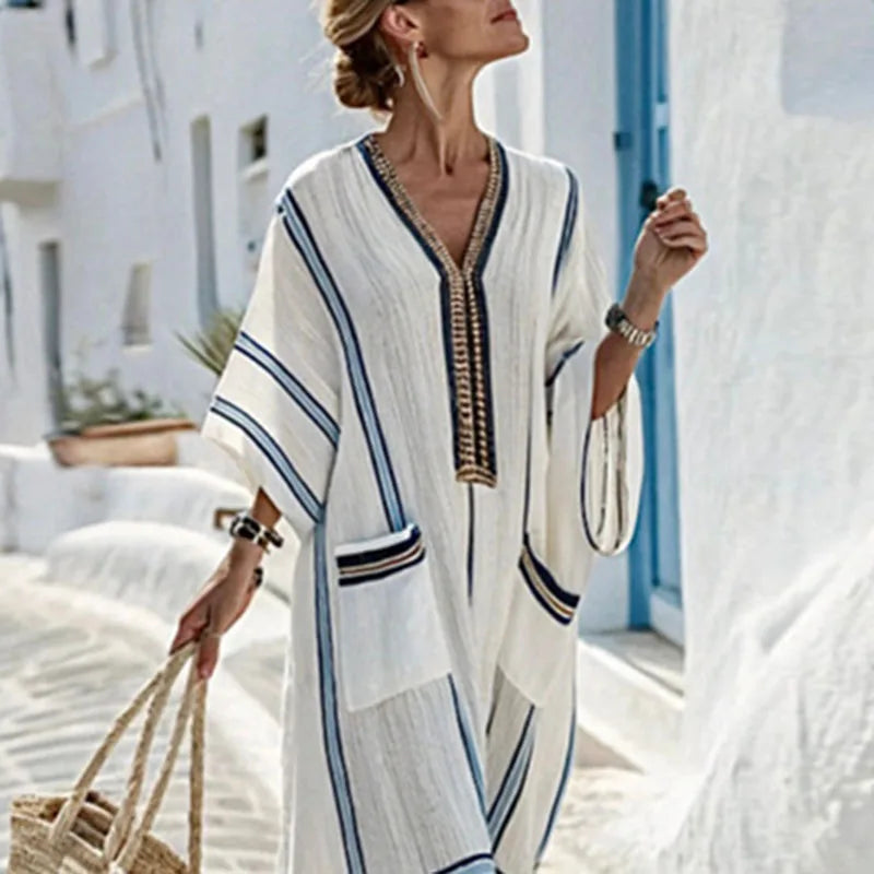 Flowy women's kimono maxi dress with V-neck, designed for beach vacations. Features comfortable relaxed fit & pockets.
