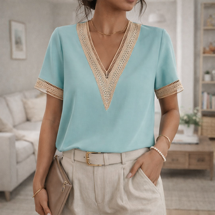 Women's short sleeve V-neck blouse, adorned with feminine lace trim. Perfect for casual elegance.