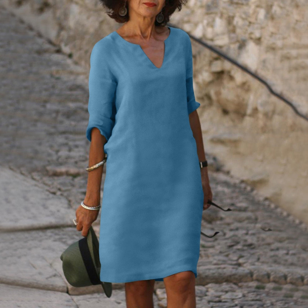 Women's casual V-neck midi dress, relaxed fit, perfect for enjoying summer activities.
