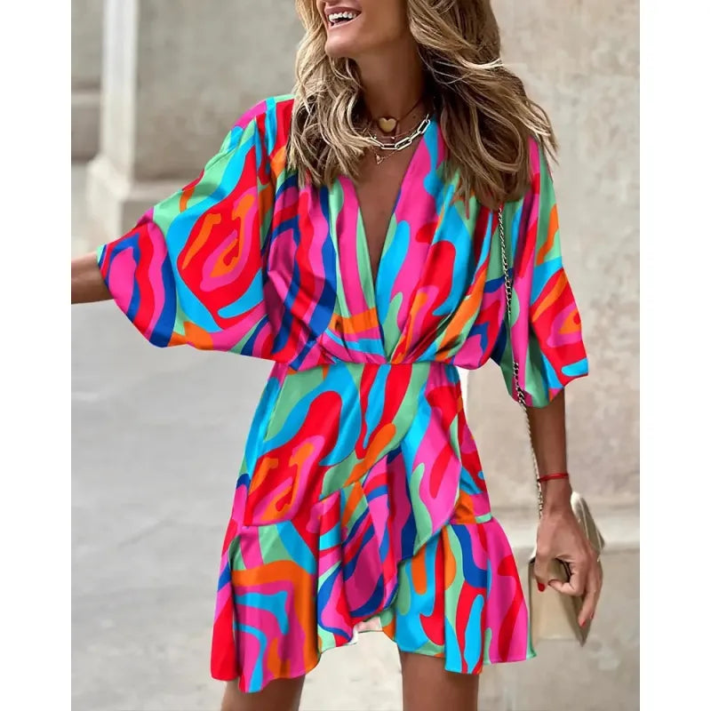 Elegant V-neck mini dress with charming ruffles and a unique abstract print, suitable for day or night.
