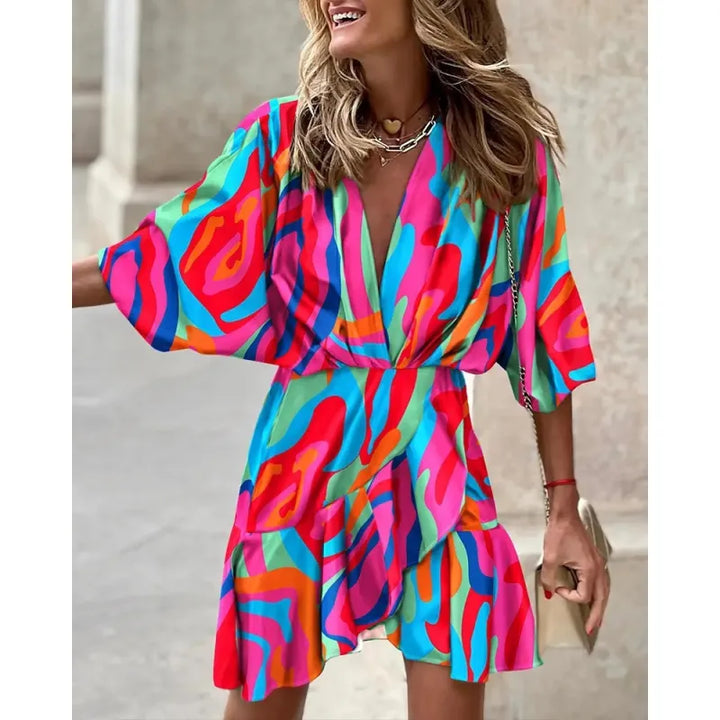 Elegant V-neck mini dress with charming ruffles and a unique abstract print, suitable for day or night.