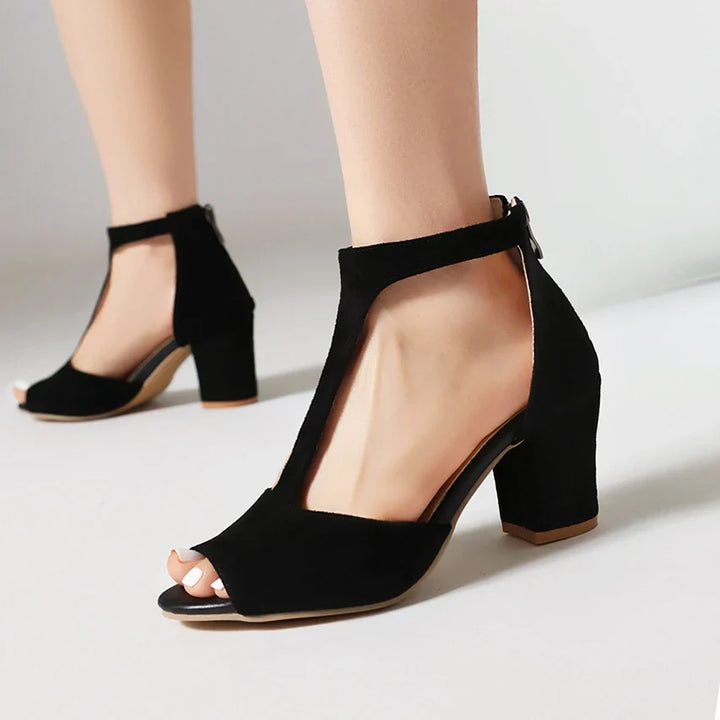 Women's Valdora elegant block heels with T-strap and open toe. Comfortable day-to-night footwear, available in black.