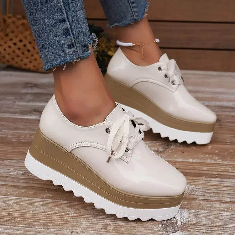 Verona Gloss women's platform sneakers, highlighting glossy texture & lace-up detail. Chic casual footwear.