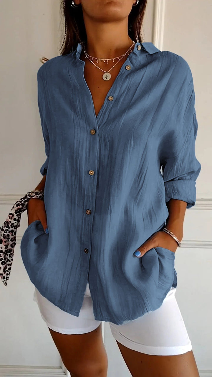 Lightweight women's long sleeve button-down shirt, a relaxed fit blouse for summer beach style.