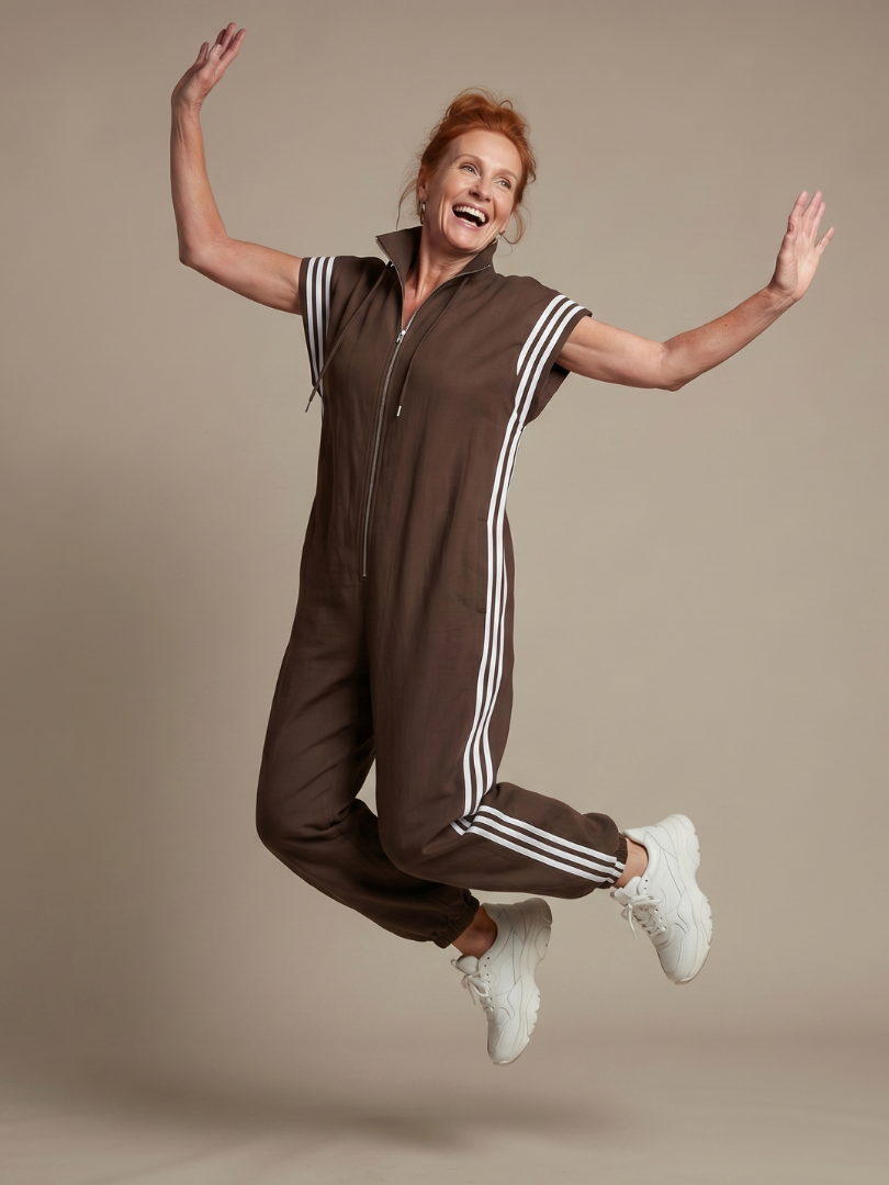 Relaxed fit striped zip front jumpsuit for women, suitable for work or leisure.