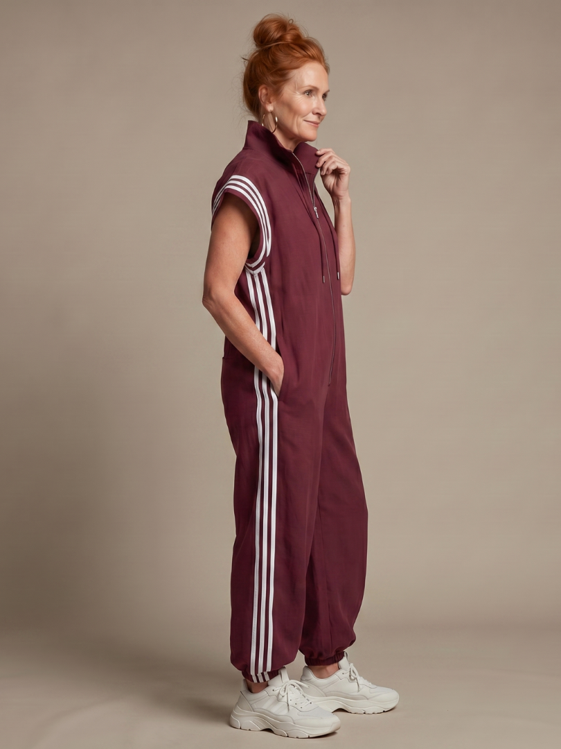 Comfortable ladies' striped zip front jumpsuit with a relaxed fit and cap sleeves.
