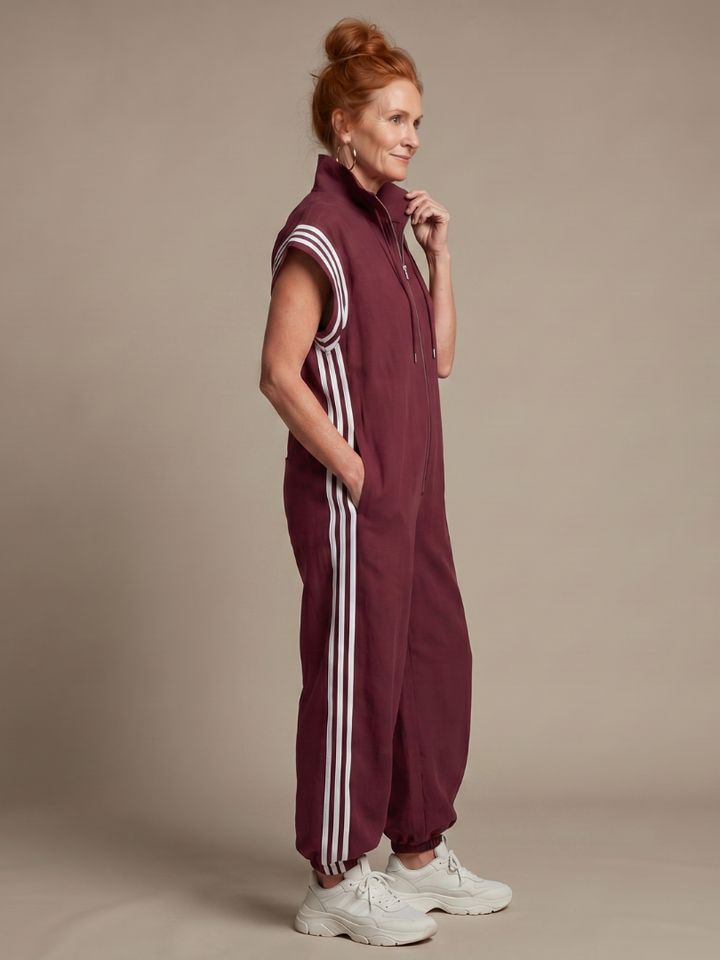 Comfortable ladies' striped zip front jumpsuit with a relaxed fit and cap sleeves.