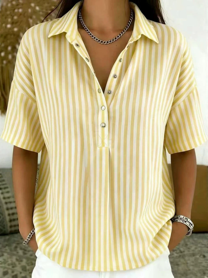 Relaxed fit women's blouse with chic vertical stripes & half-button placket. Great for spring fashion.