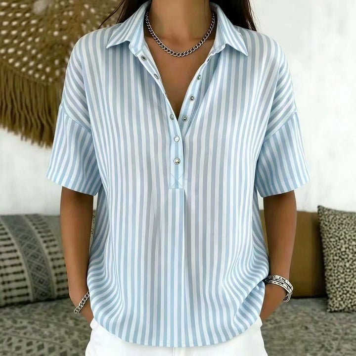 Short sleeve women's vertical stripe blouse. Relaxed fit, half-button, perfect for spring/summer workwear.