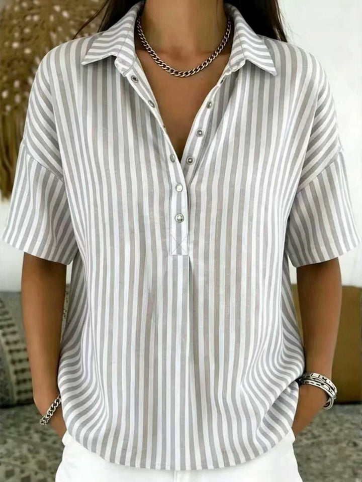 Chic women's vertical stripe top with a relaxed fit & half-button detail, ideal for versatile styling.