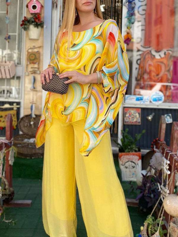 Stylish women's abstract print two-piece set featuring a batwing top and comfy wide leg pants.