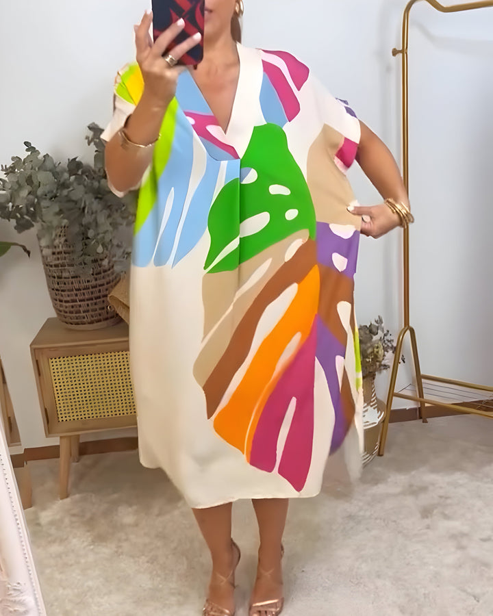 Women's short sleeve V-neck shift dress in a vibrant abstract print, ideal for casual summer style.