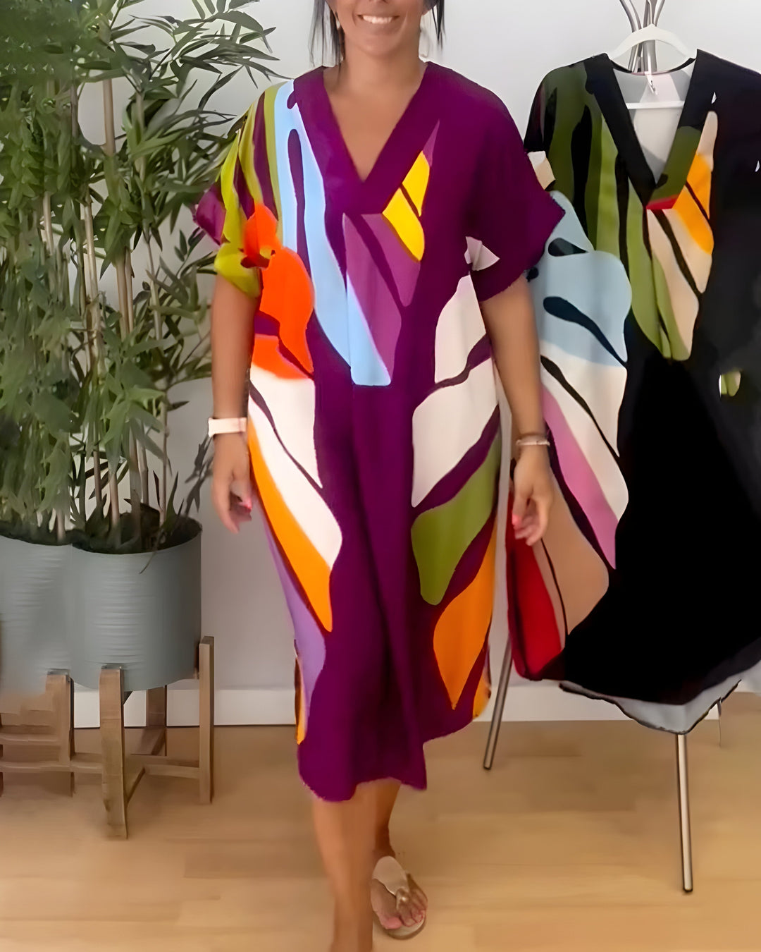 Summer women's V-neck shift dress with a vibrant abstract print & short sleeves, above knee style.