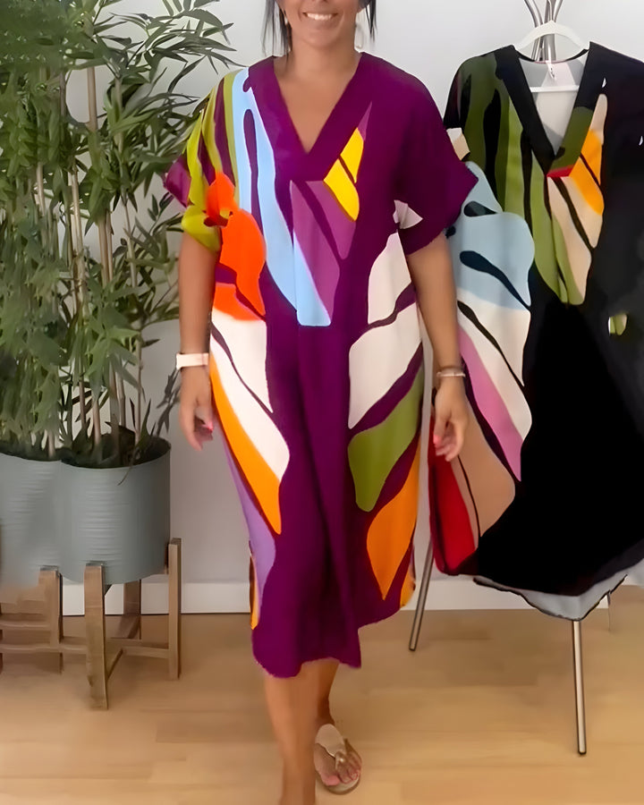 Summer women's V-neck shift dress with a vibrant abstract print & short sleeves, above knee style.