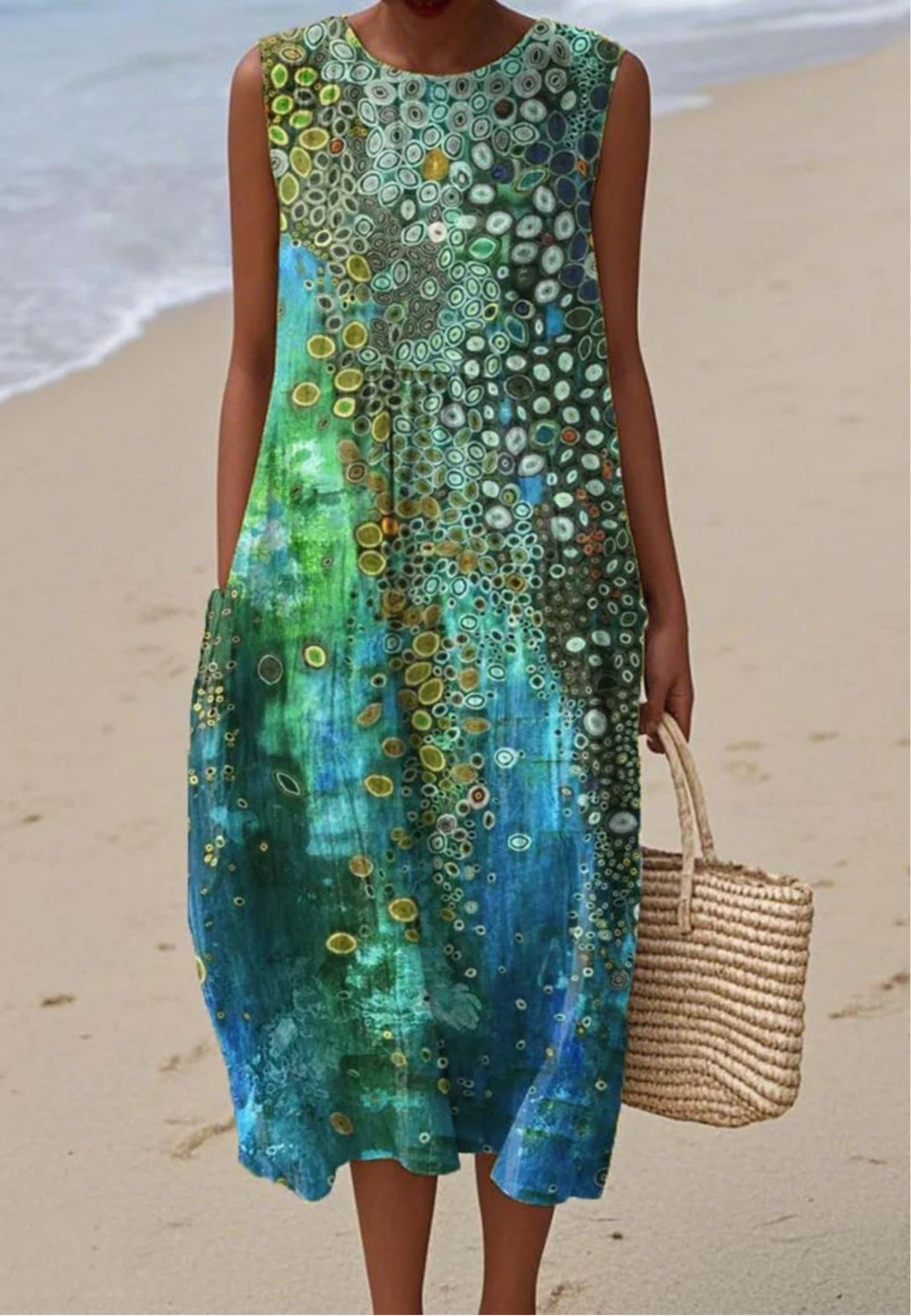 Women's vibrant abstract summer dress with flowing fabric, sleeveless design, perfect for casual wear or beach outings.