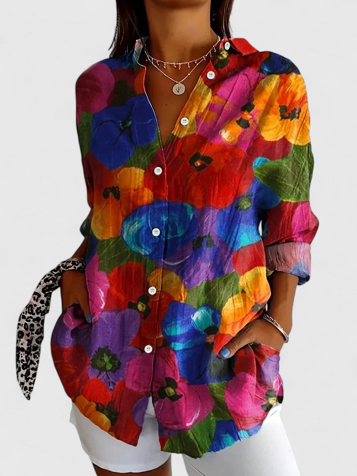Stylish women's long sleeve top with a vivid floral abstract print, ideal for casual or dressy occasions.